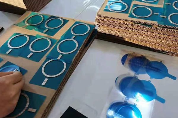 A quality control engineer inspecting magnets in a factory setting