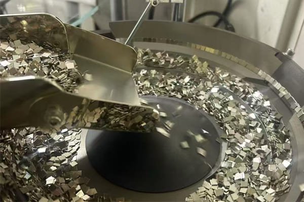 A rugged, stainless-steel-encased industrial magnetic separator in a processing plant.